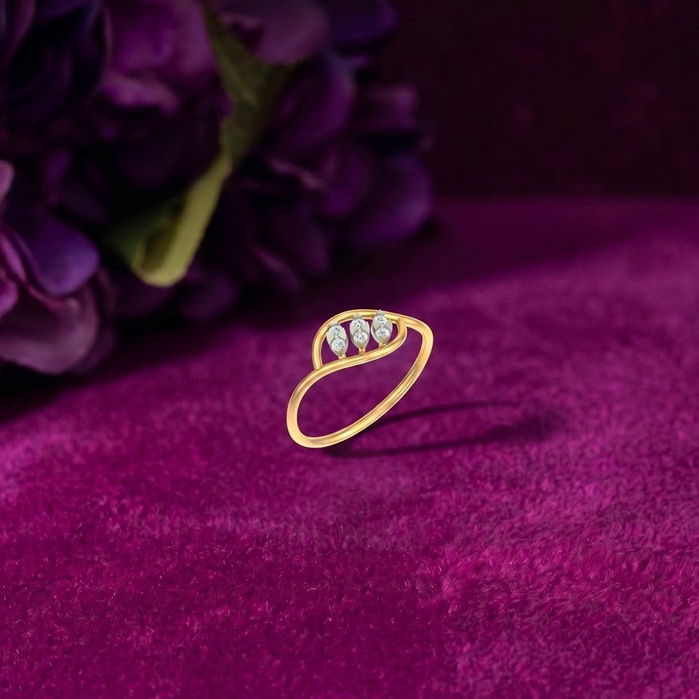 Gold and diamond with triple marquise leaf openwork ring on a magenta surface.