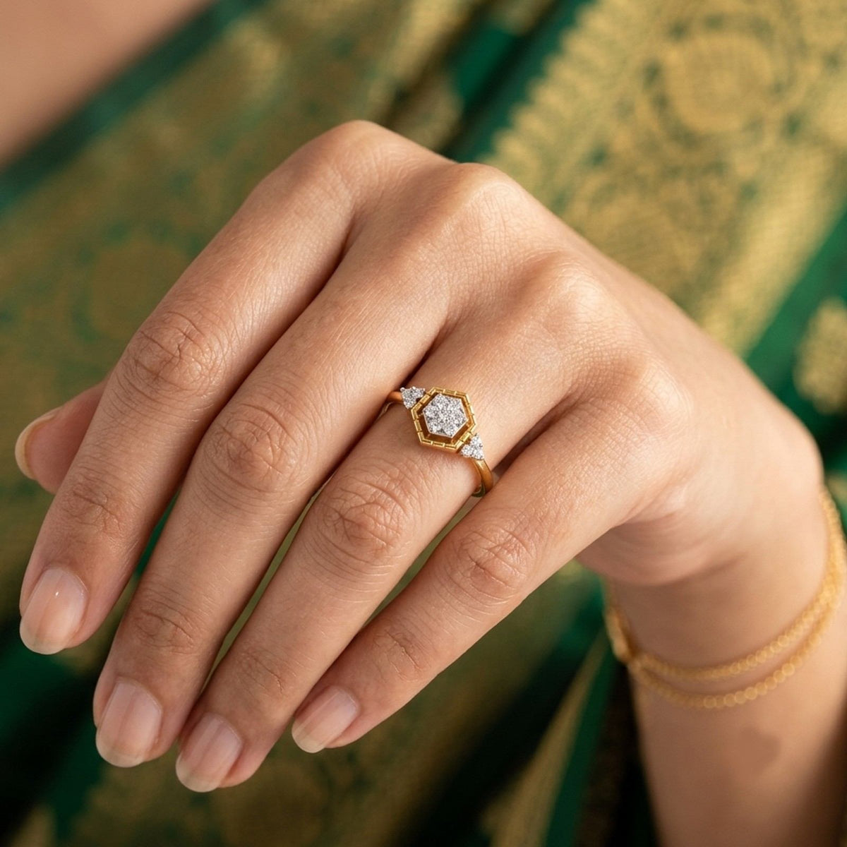 Gold ring with diamond accents on a person's finger.