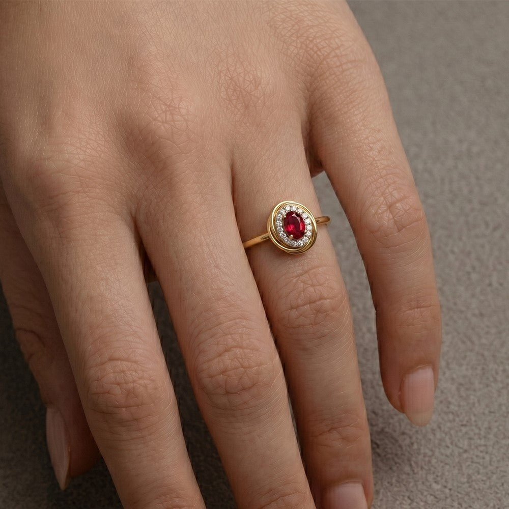 Close-up shot of a gold and diamond with ruby gemstone ring.