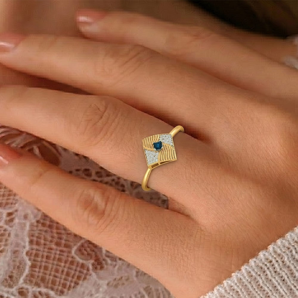 Close-up shot of a gold and diamond with sapphire gemstone ring.