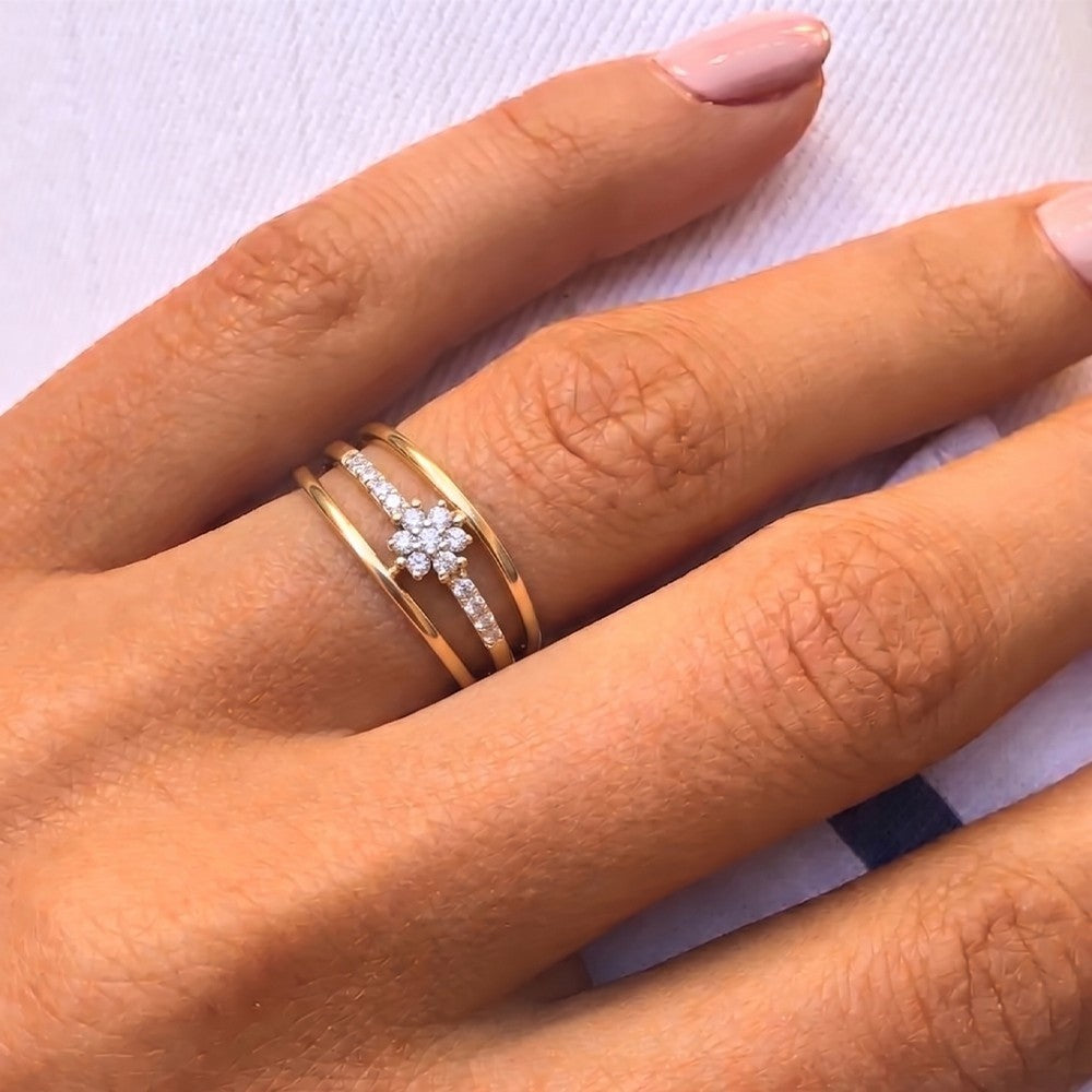 Close-up shot of a gold and diamond with cluster floral ring.