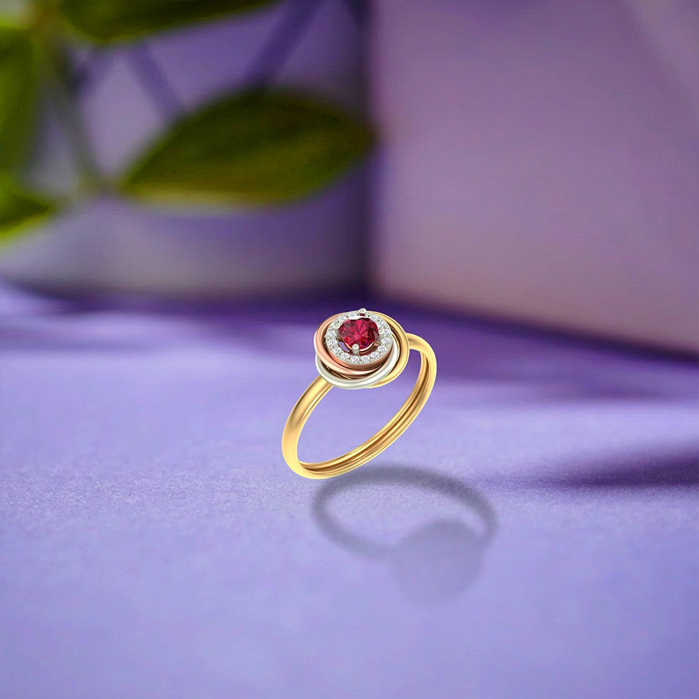 Gold and diamond with ruby gemstone on a blue surface.