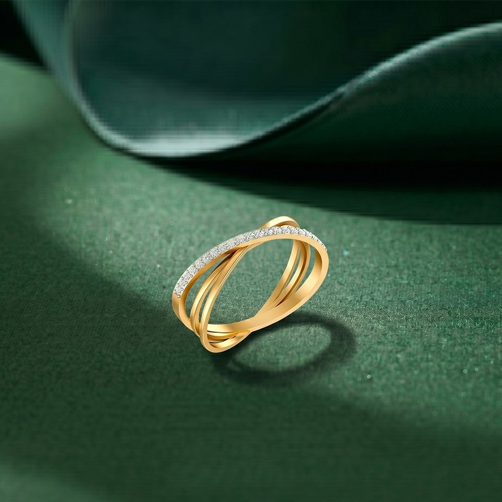 Gold ring with diamonds on a green surface