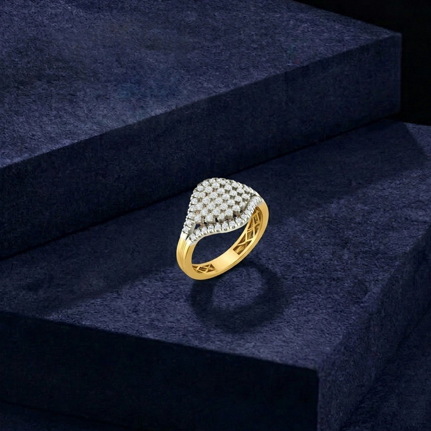 Gold ring with diamonds on a dark blue textured surface
