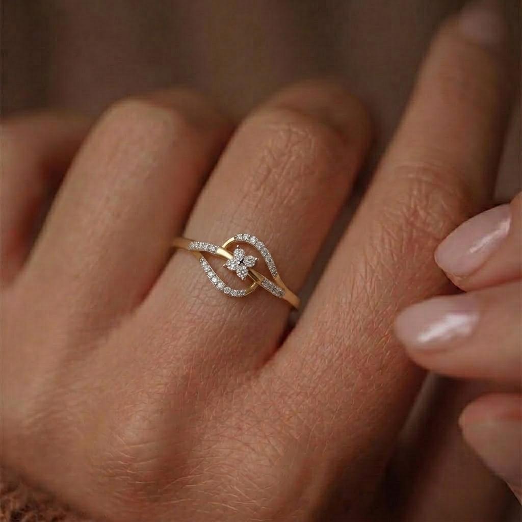 A close-up of a gold ring with a butterfly motif and small clear stones, worn on a person's finger.