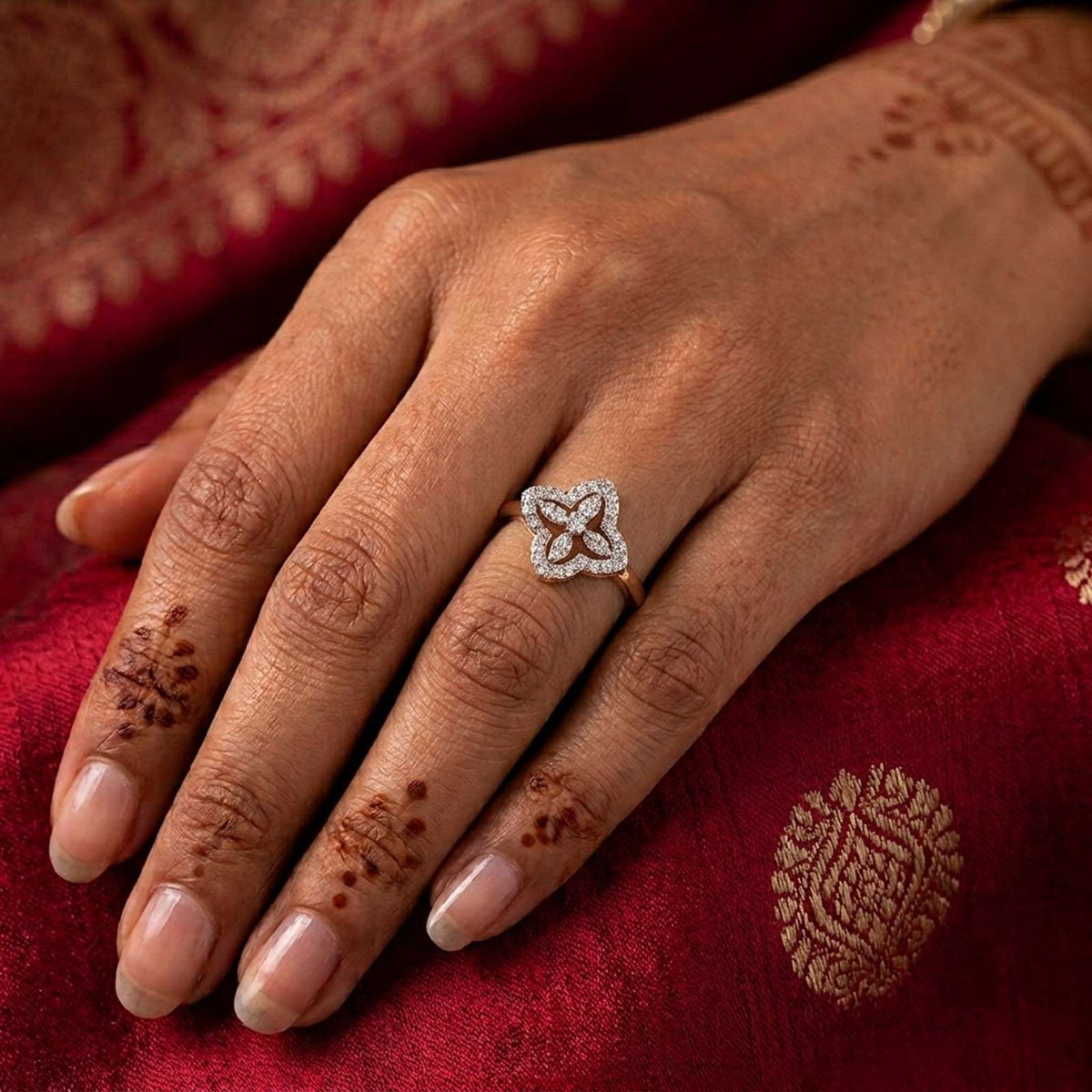 Close-up shot of a gold ring featuring a floral design halo set ring.