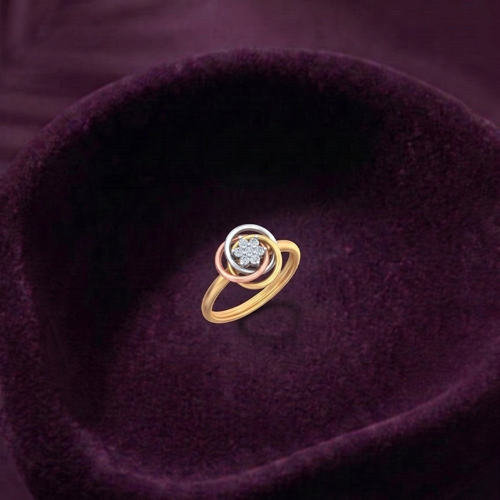 Gold ring with a diamond on a purple fabric background