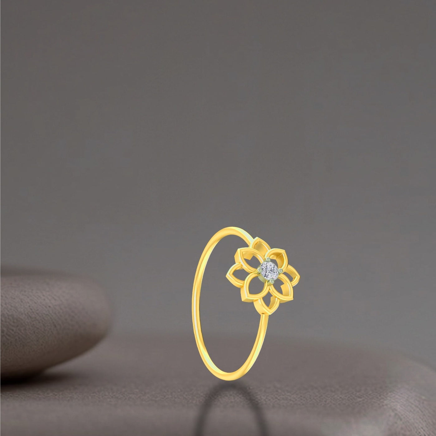 Gold ring with a floral design and diamond on a dark gray background