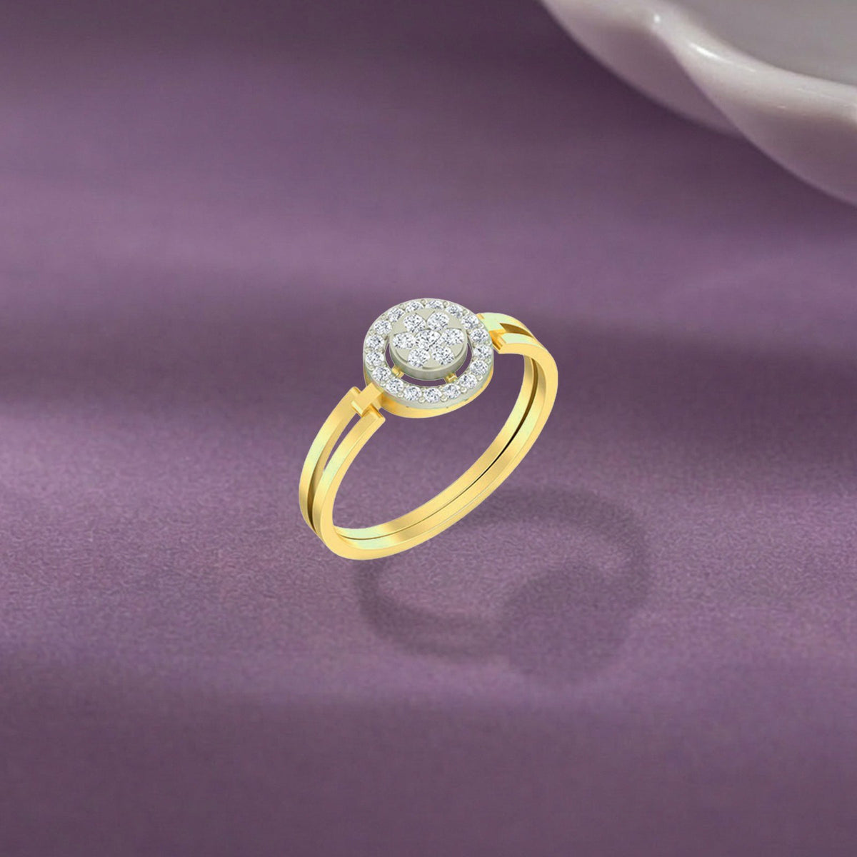 Gold and diamond with cluster halo setting on a purple surface.