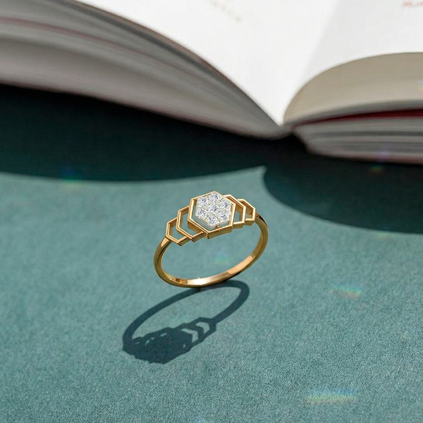 Gold and diamond with cluster setting on a green surface.