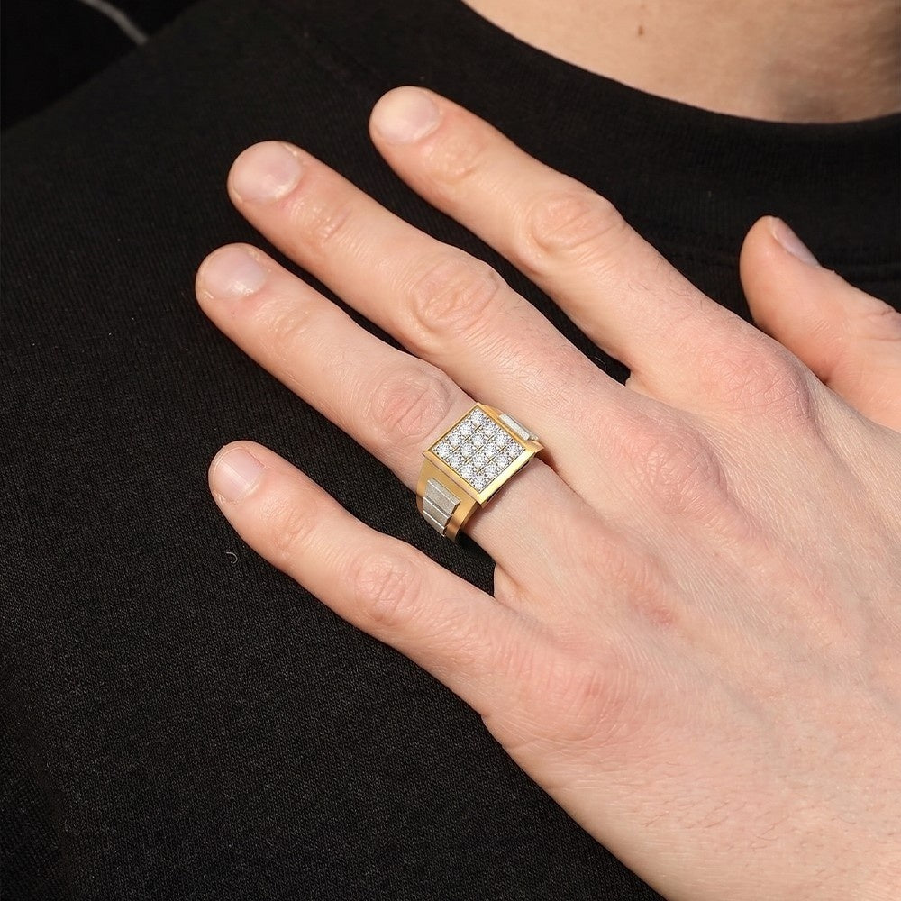 Hand wearing a gold ring with gemstones on a black background