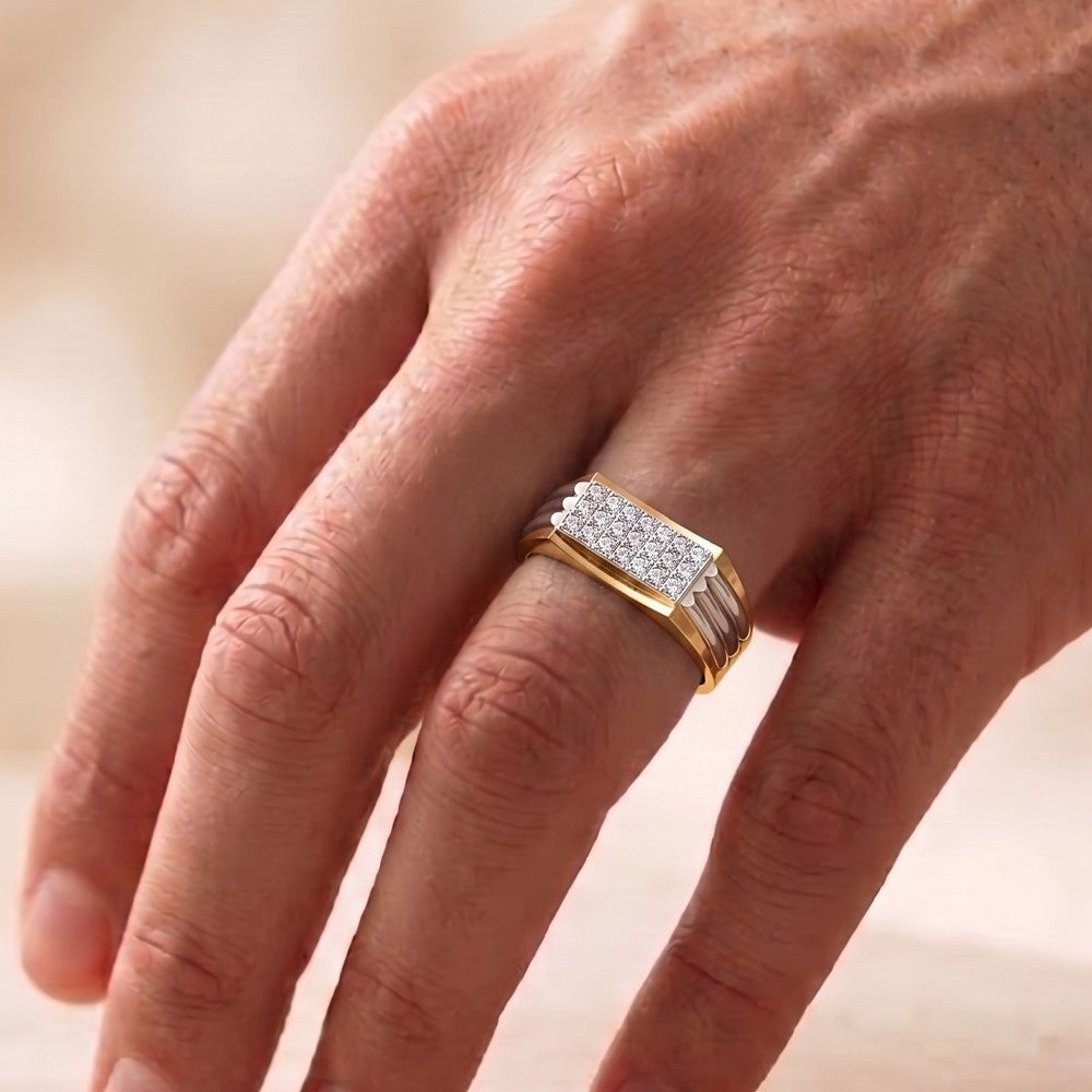 Gold ring with diamonds on a person's finger against a blurred background