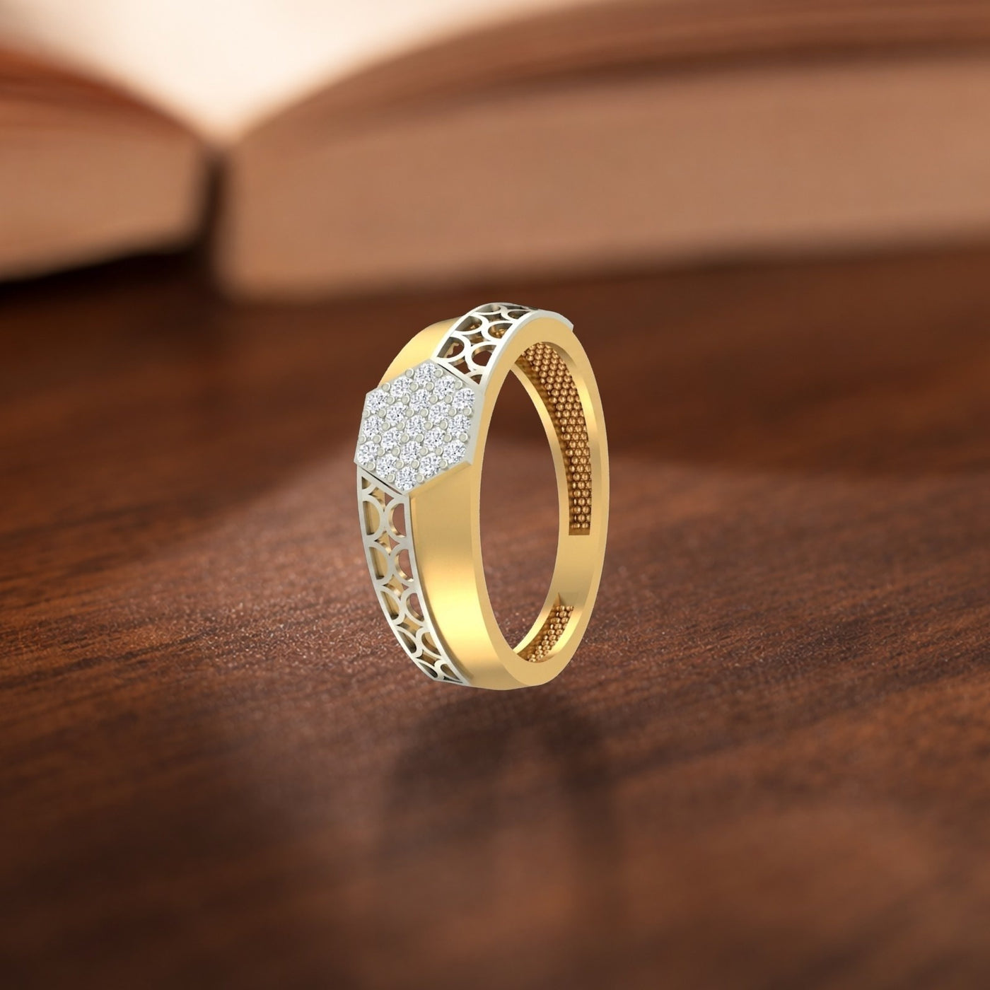 Gold and diamond men's ring on a wooden surface.