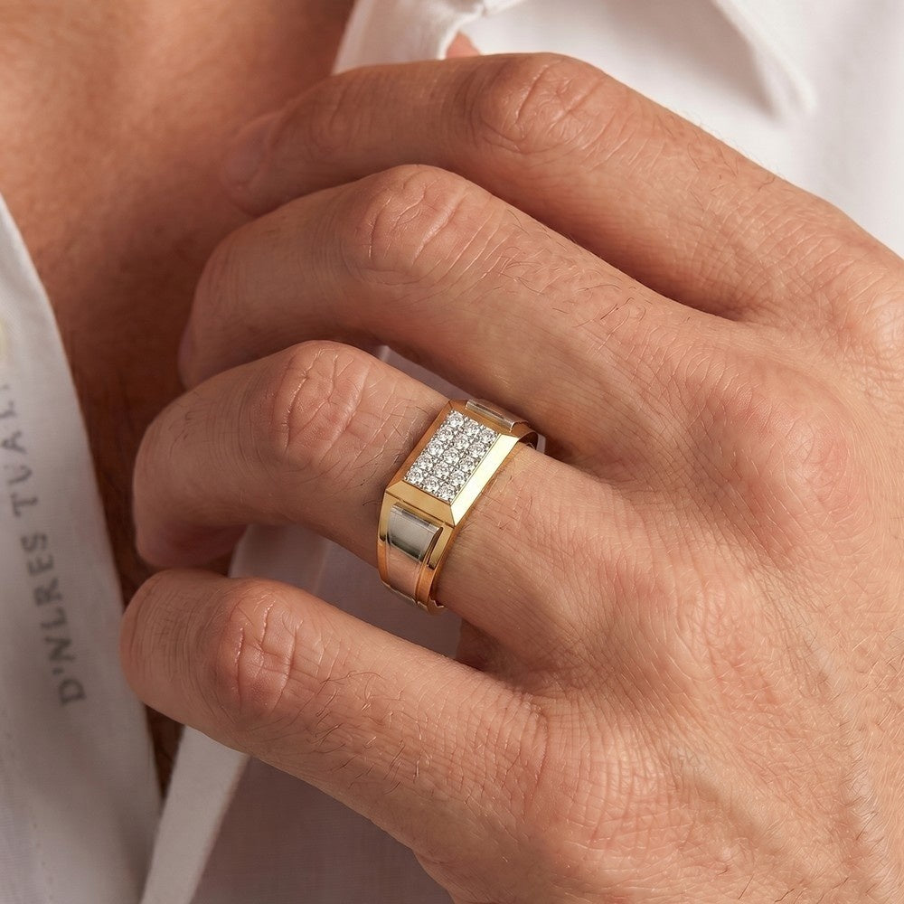 Close-up of a hand wearing a gold ring with diamonds on a white background