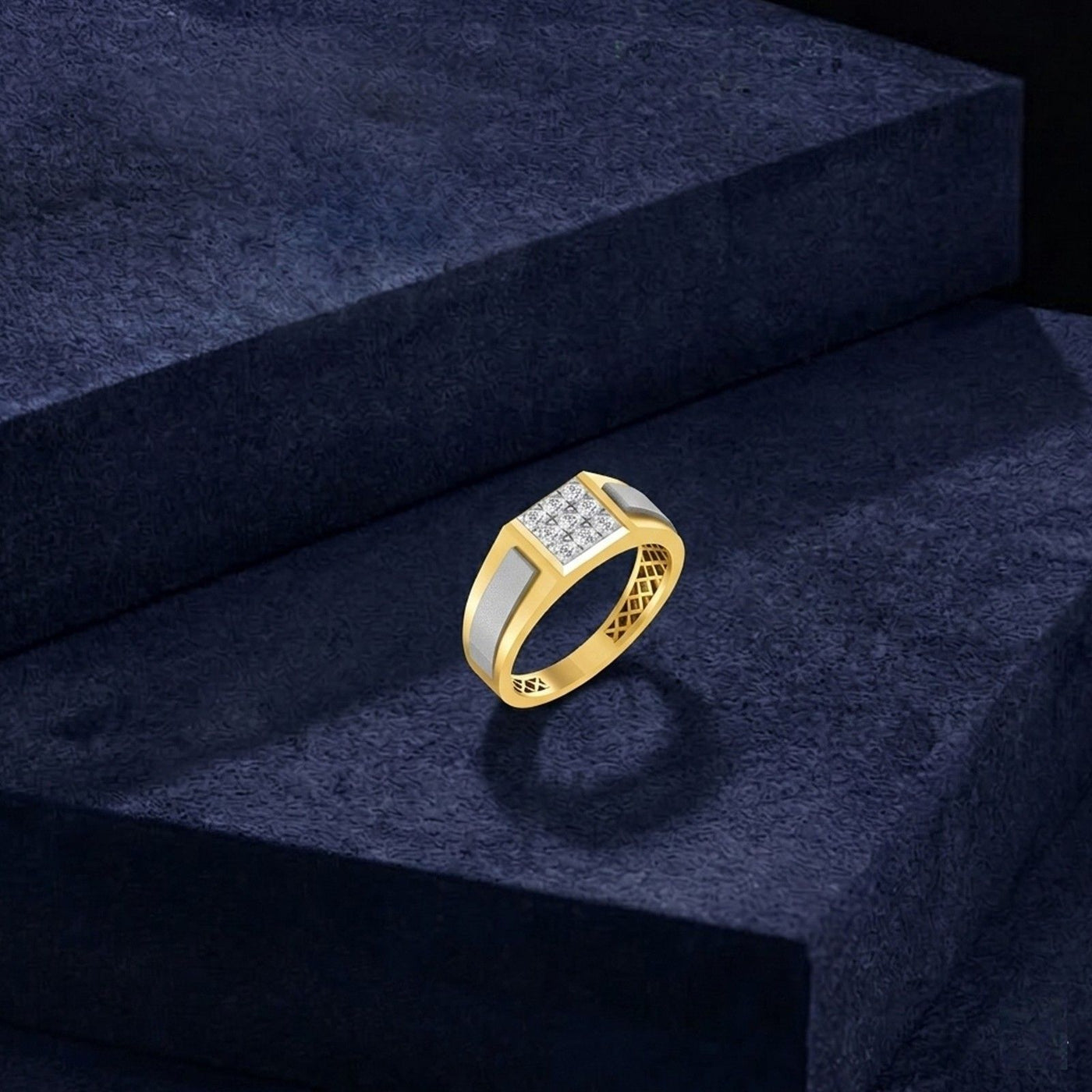 Gold ring with diamonds on a dark blue textured surface.