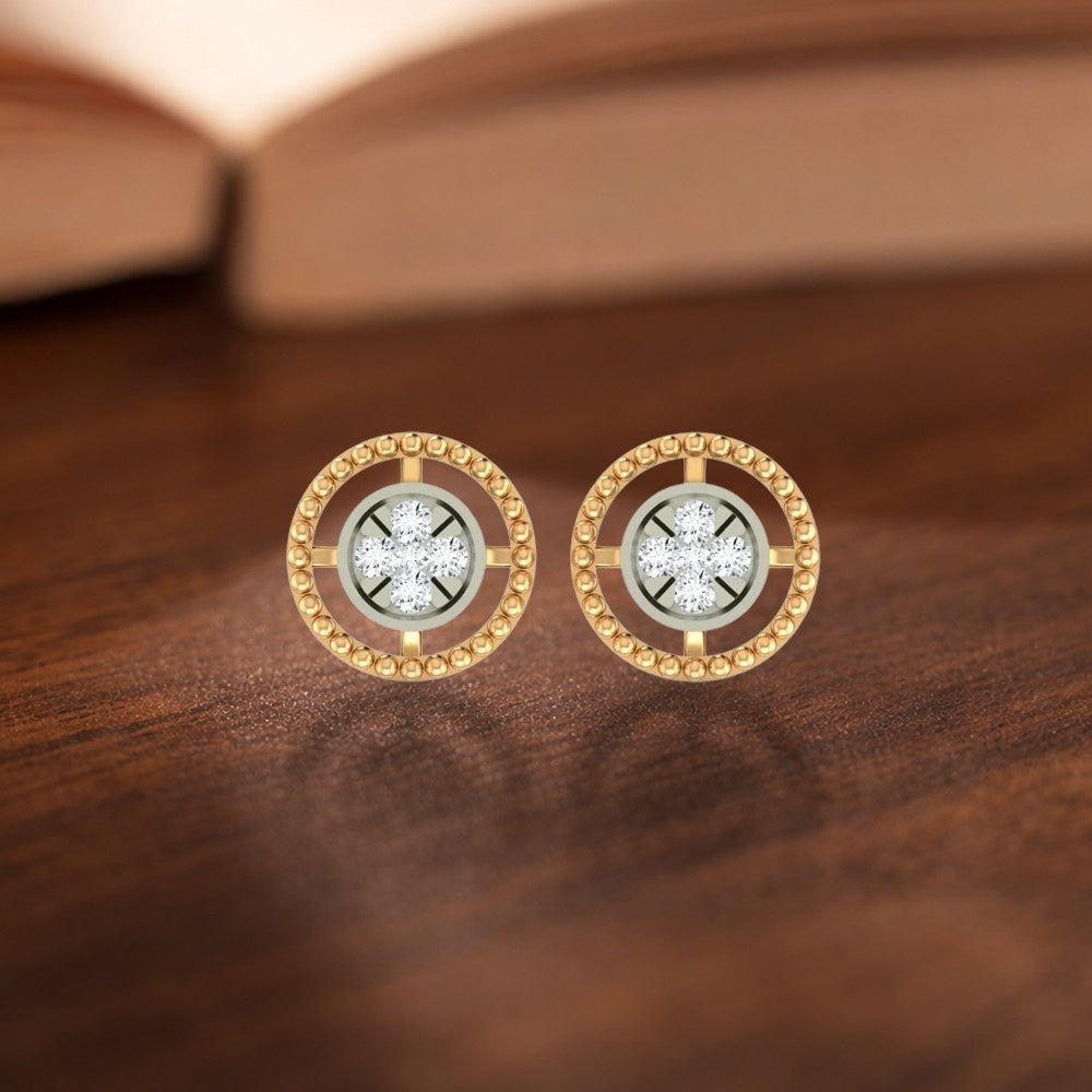 A pair of gold round stud halo design earrings, displayed on a dark wooden surface.