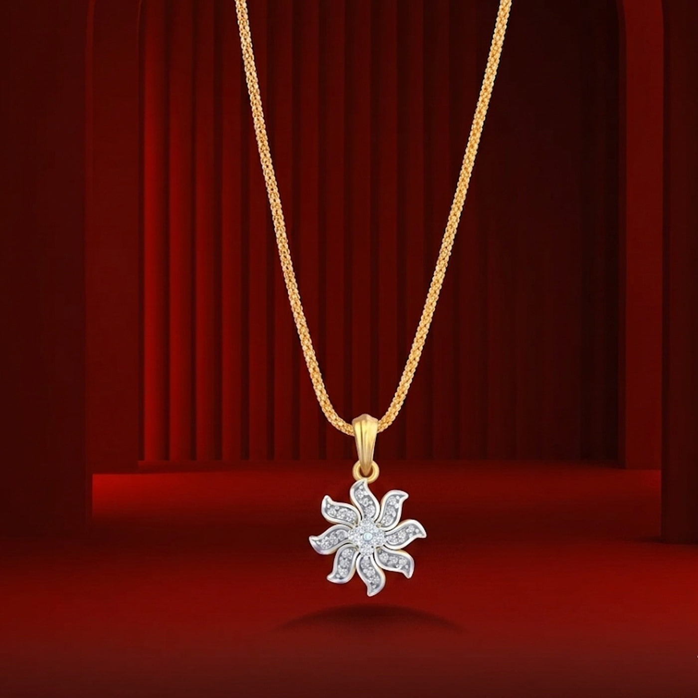 Gold and diamond pendant on a red background