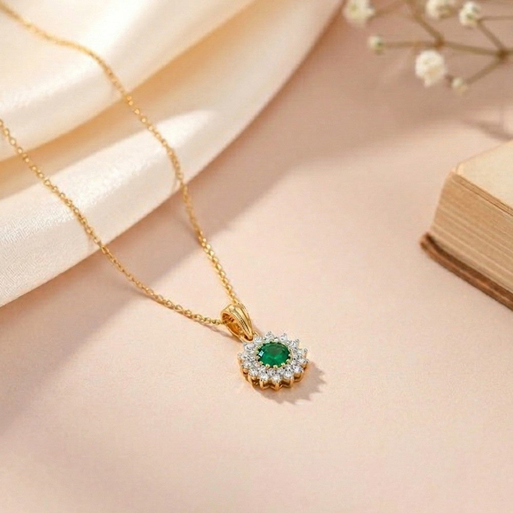 Gold pendant with a green gemstone pendant on a soft beige background