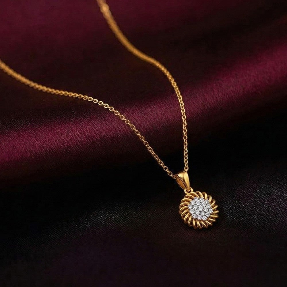 Gold and diamond sunflower-shaped pendant on a dark fabric background
