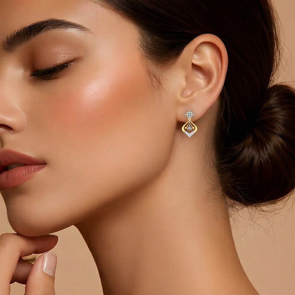 Close-up of a woman wearing a gold and diamond earring against a beige background.