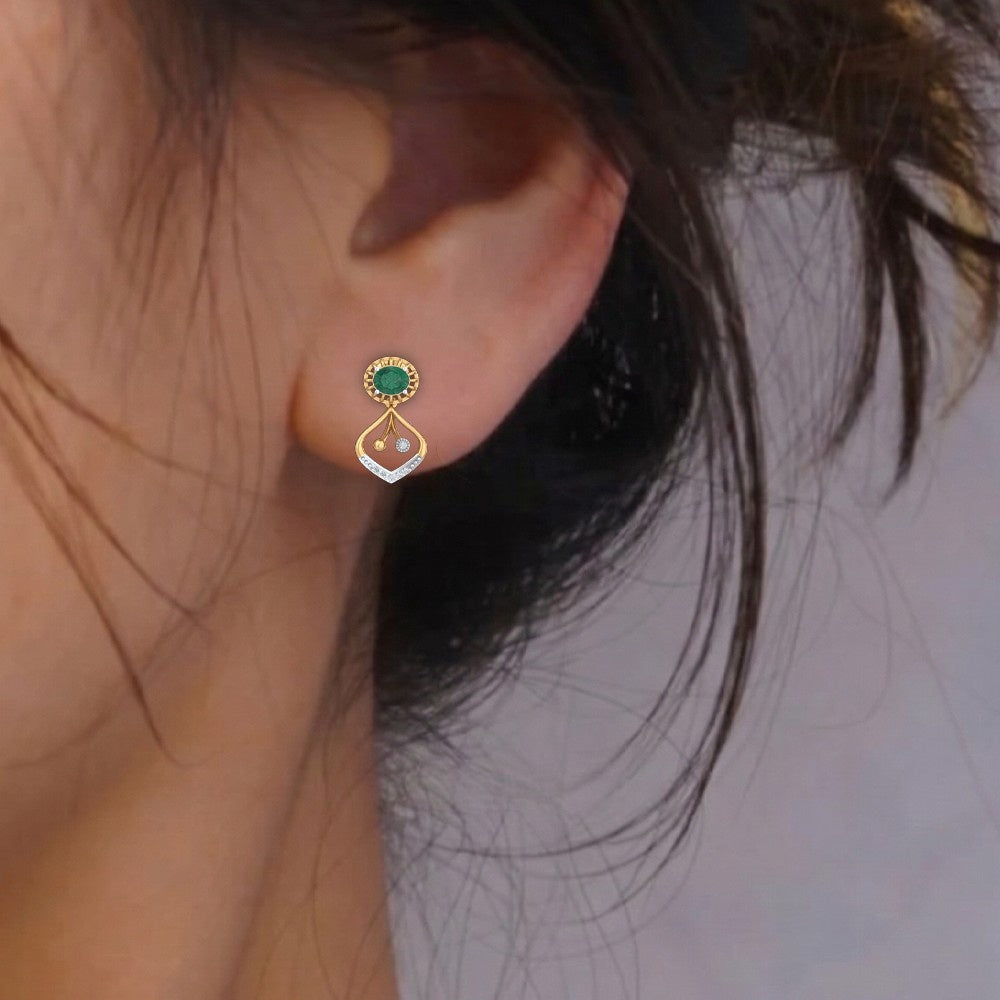 Close-up shot gold and diamond emerald stone earring.