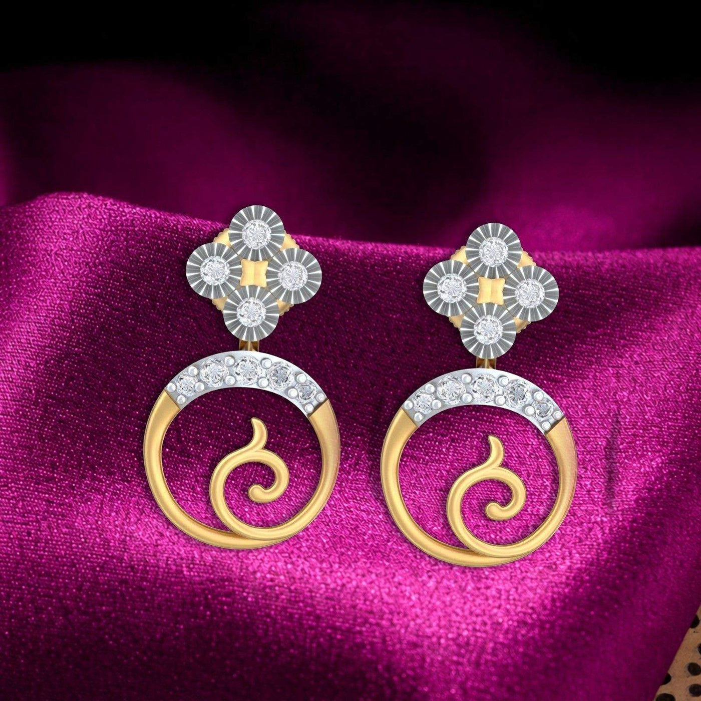 Gold and diamond earrings with floral design on a textured magenta satin fabric background.
