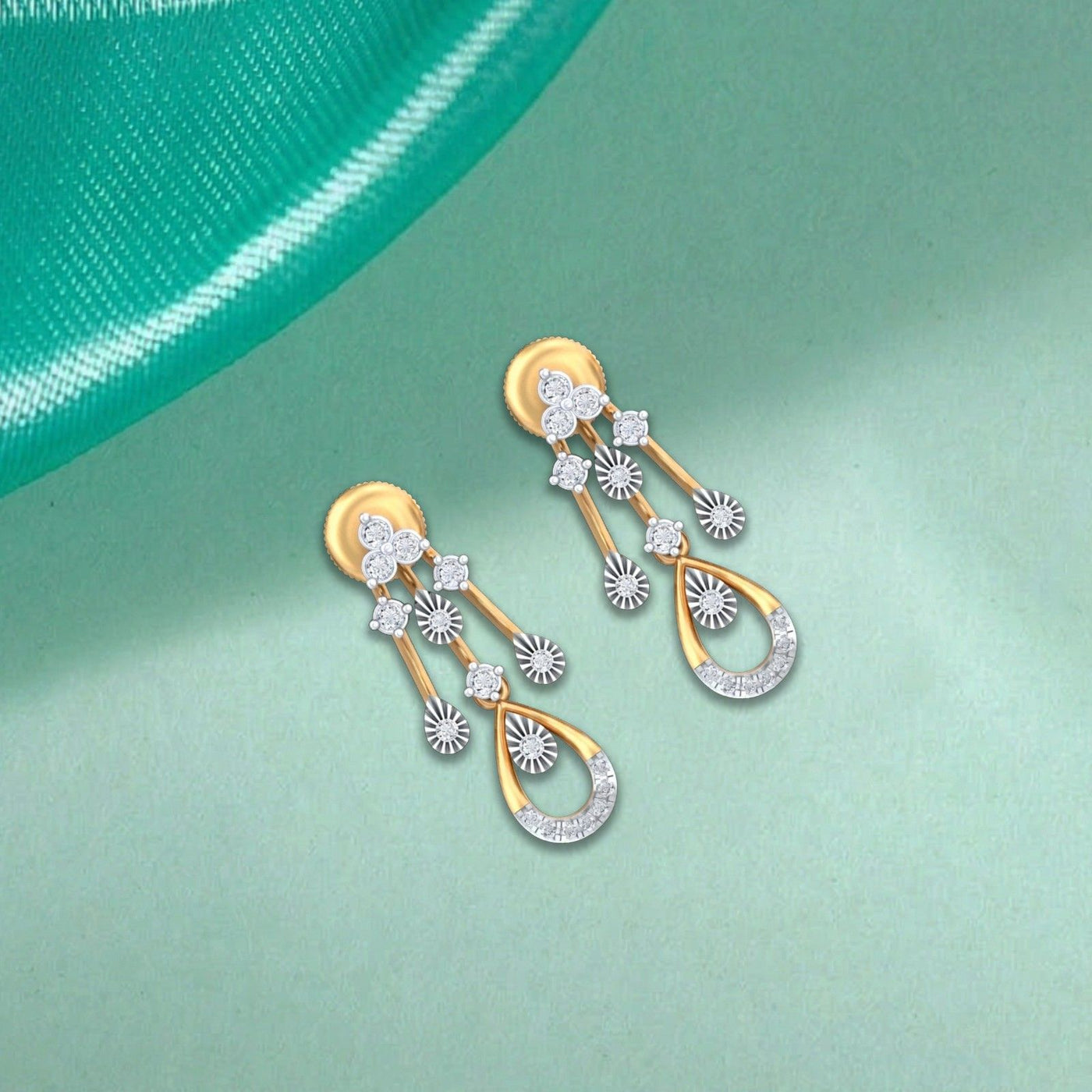 Pair of gold and diamond dangler earrings on a blue background.