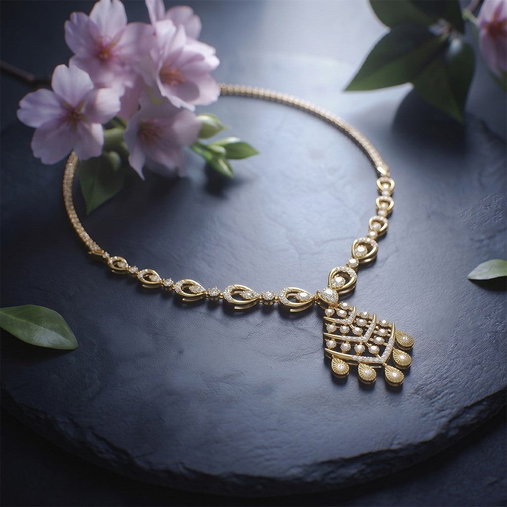 Gold necklace with a decorative pendant on a dark surface with pink flowers and green leaves.