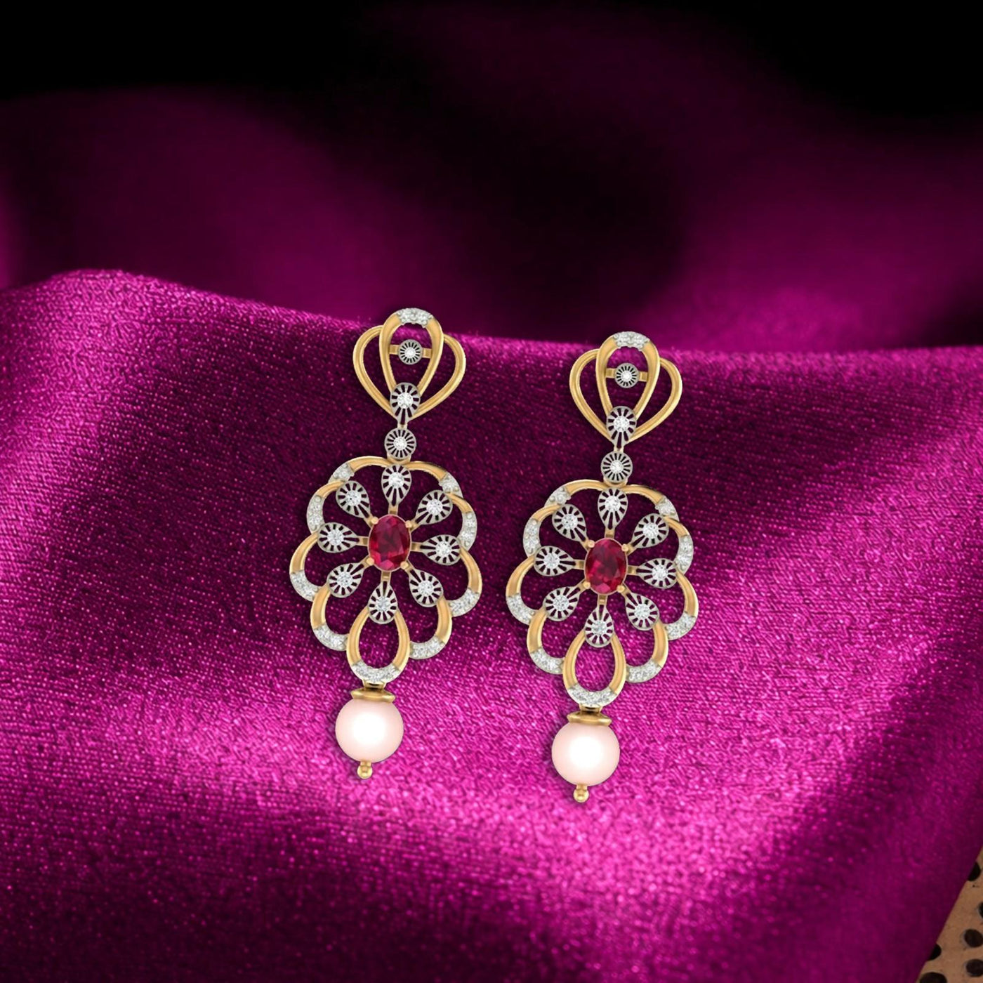 Gold drop earrings featuring a central red gemstone surrounded by diamond on a magenta surface.