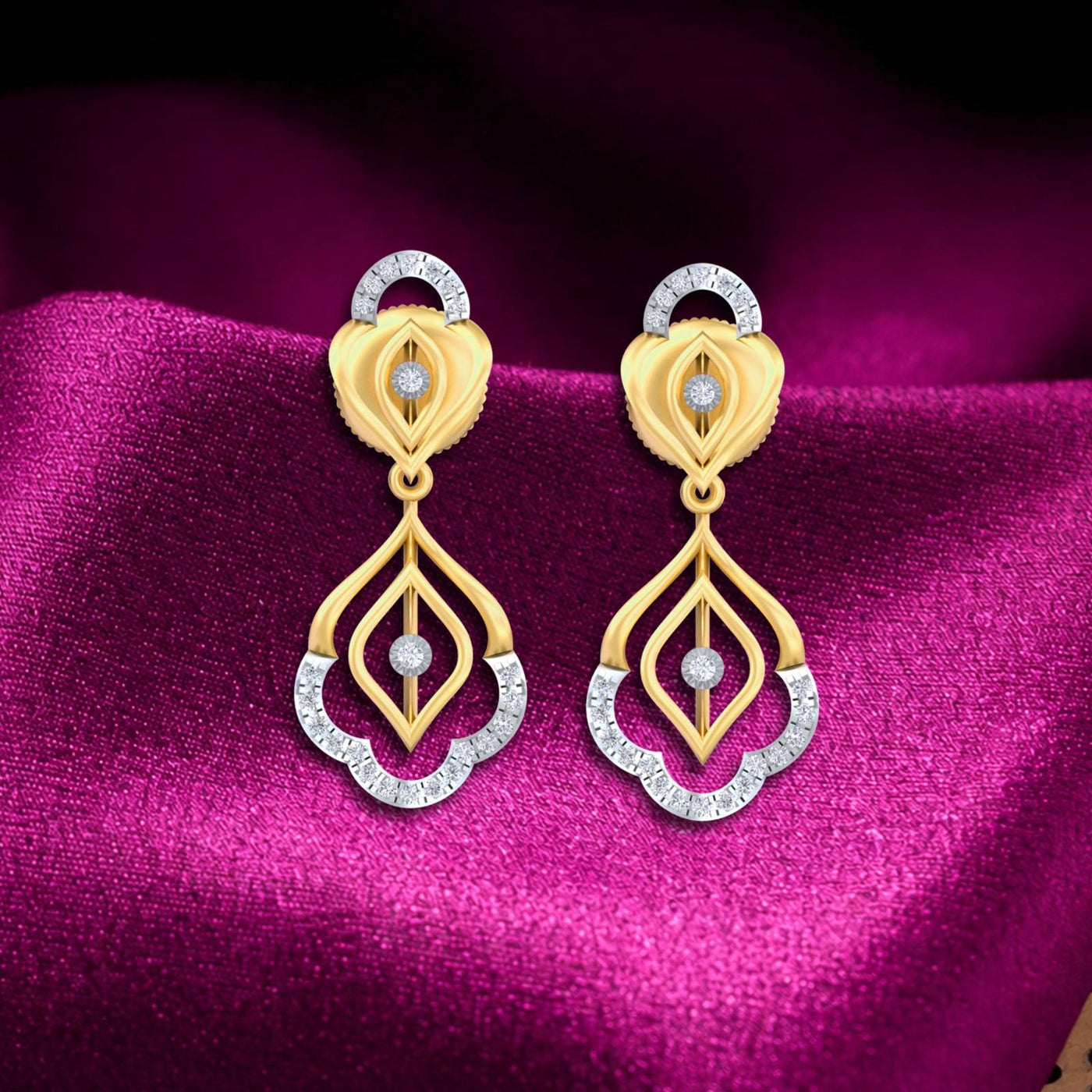 A pair of gold and diamond drop earrings, displayed on a magenta satin fabric background.