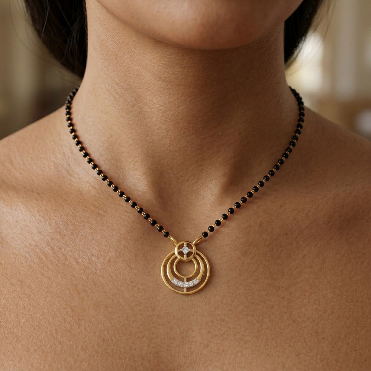 A close-up of a person wearing a black beaded mangalsutra featuring a circular gold and diamond