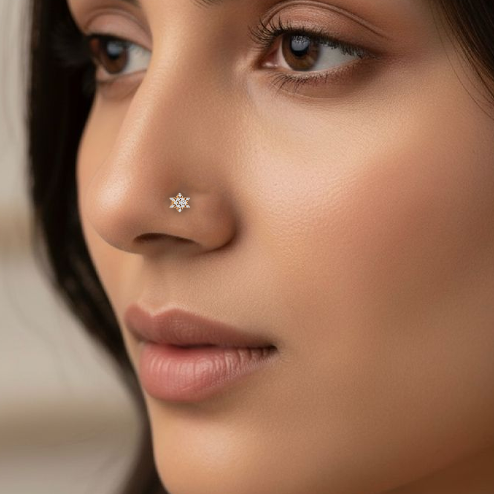 Close-up of a woman's face with a gold and diamond stud nosepin