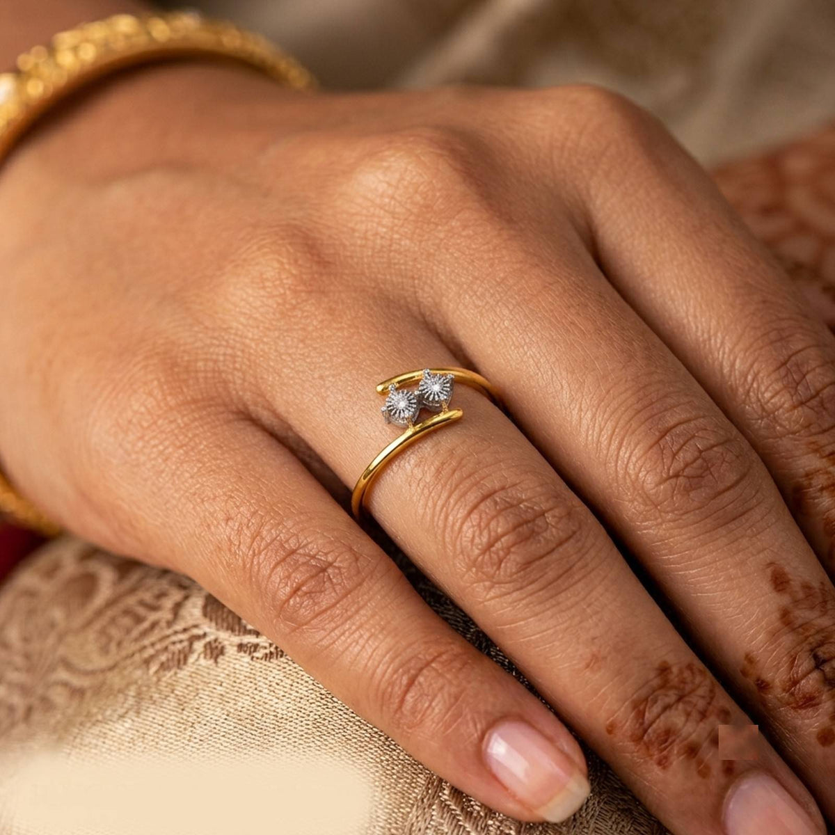 Gold and diamond ring on a persons finger.