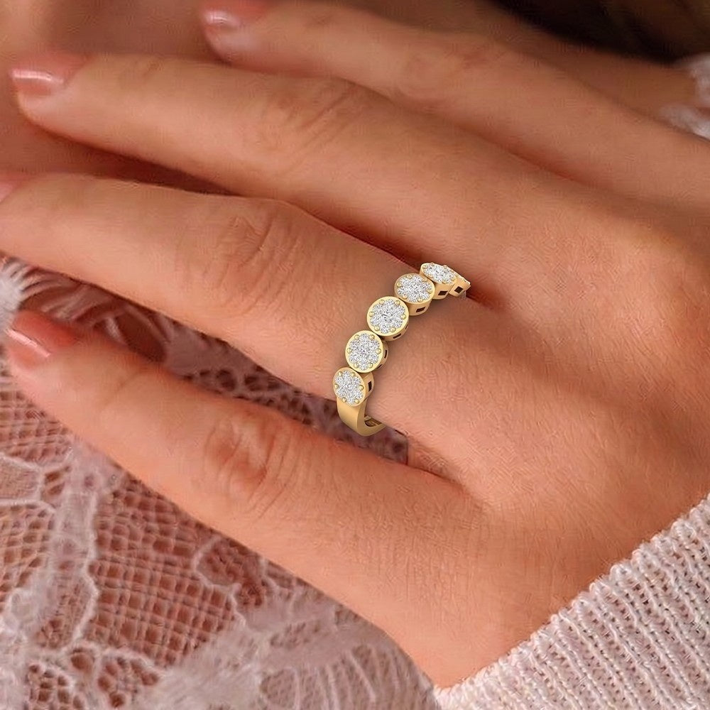 Gold ring with diamonds on a hand against a lace background