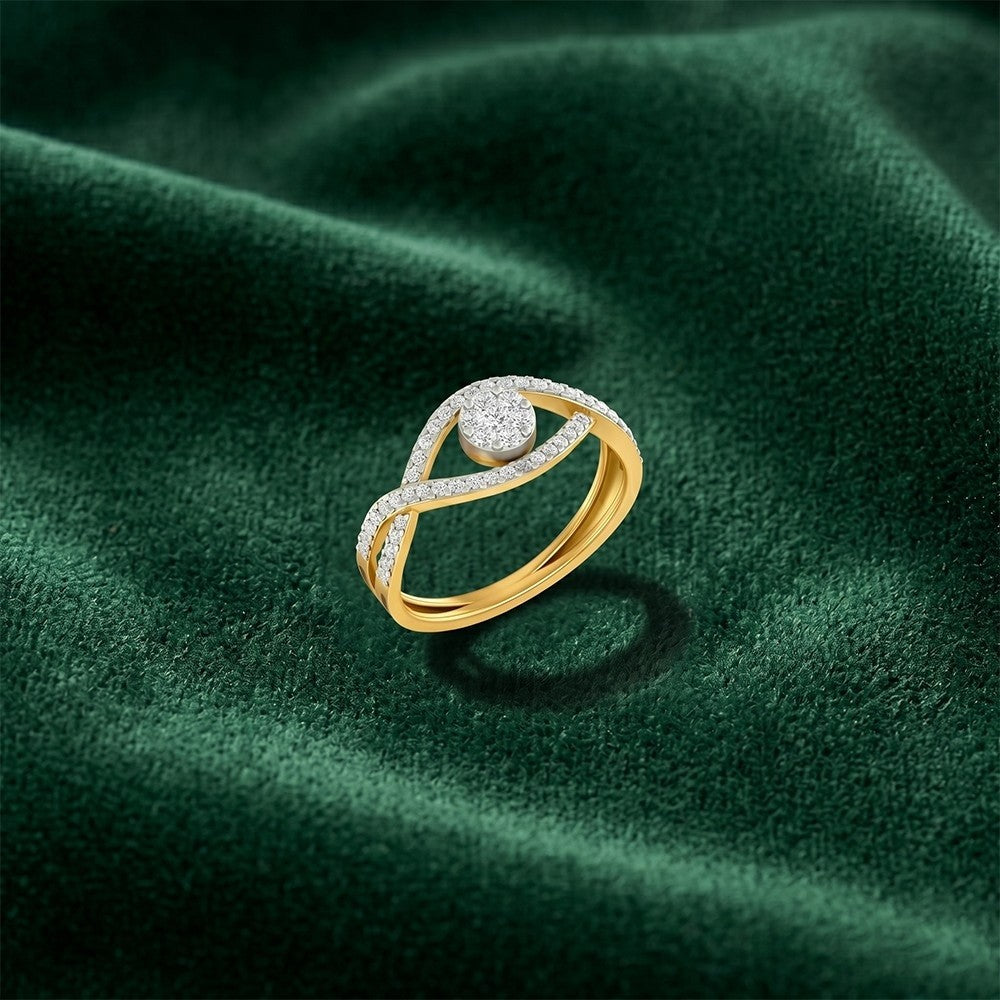 A gold and diamond ring with a round-cut clear center stone, resting on a textured dark green velvet surface.