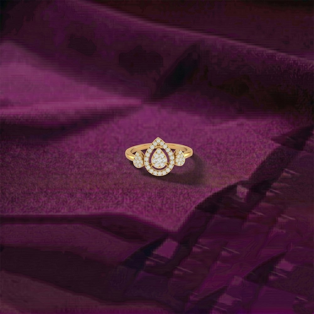 Gold ring with diamonds on a purple fabric background.