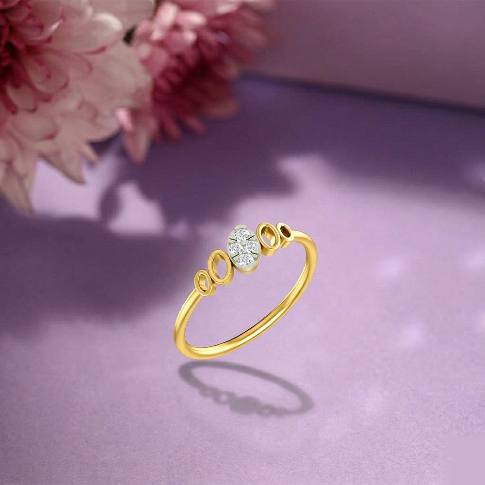 Gold and diamond with cluster setting on a purple surface.