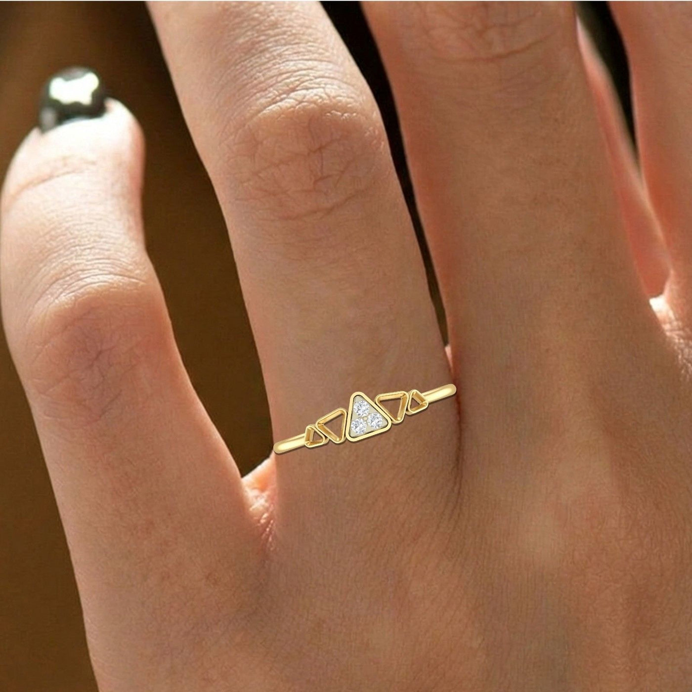Close-up shot of a ring with triangular designs and embedded diamonds ring.