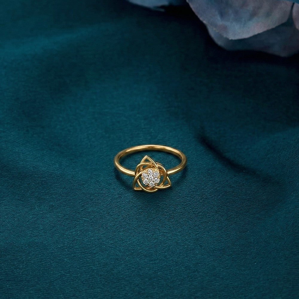 Gold and diamond with cluster setting on a teal surface.