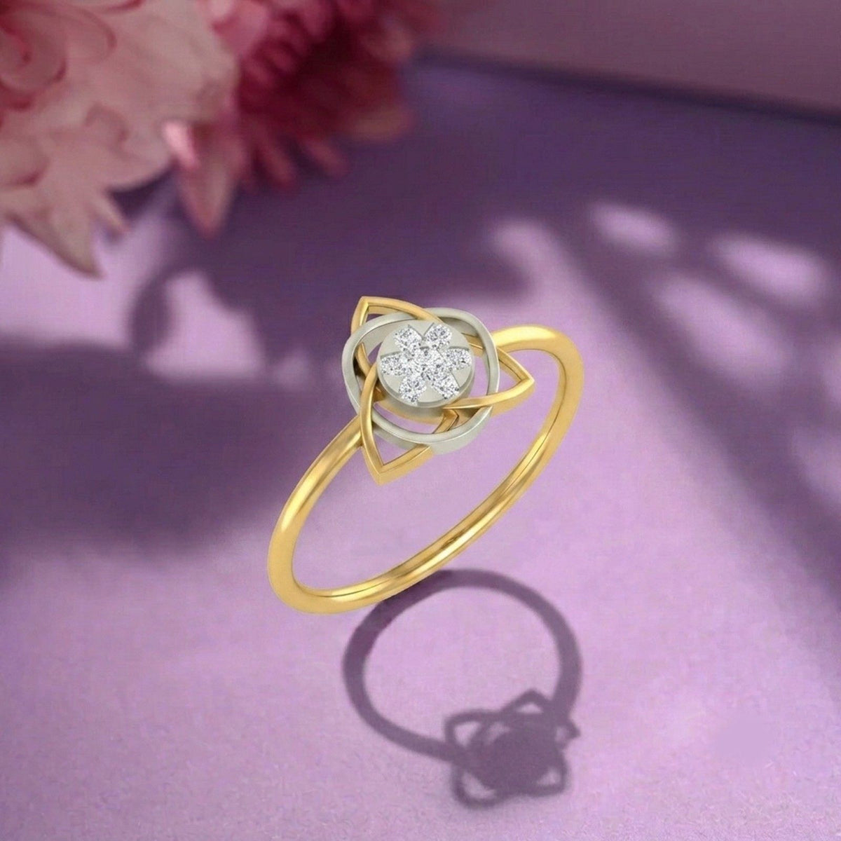 Gold and diamond with cluster setting on a purple surface.