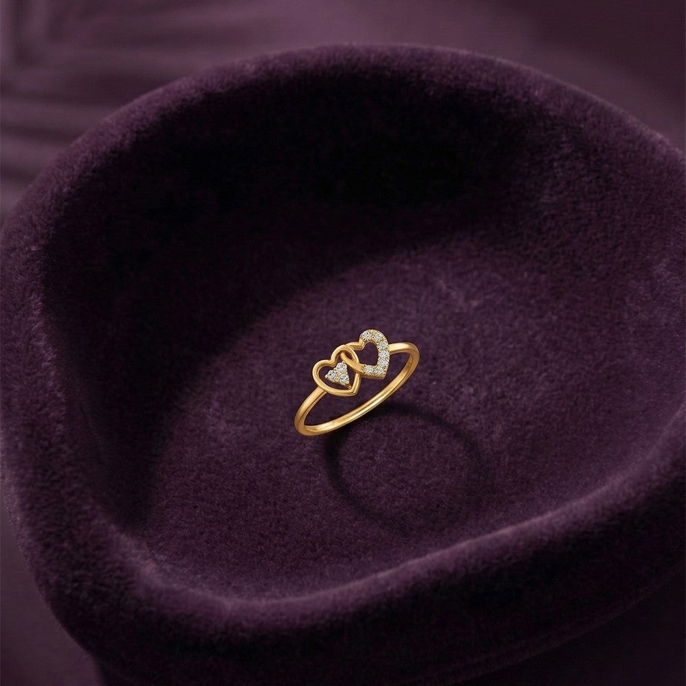 Gold and diamond with heart-shaped and cluster setting on a fabric surface.