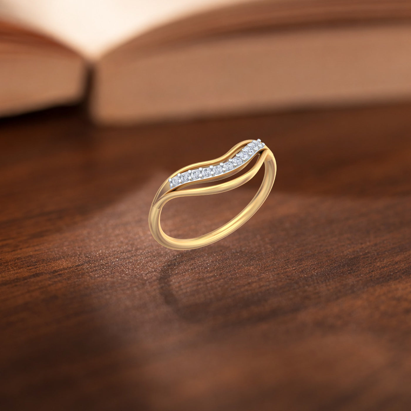 Gold and diamond with half-eternity on a wooden surface.