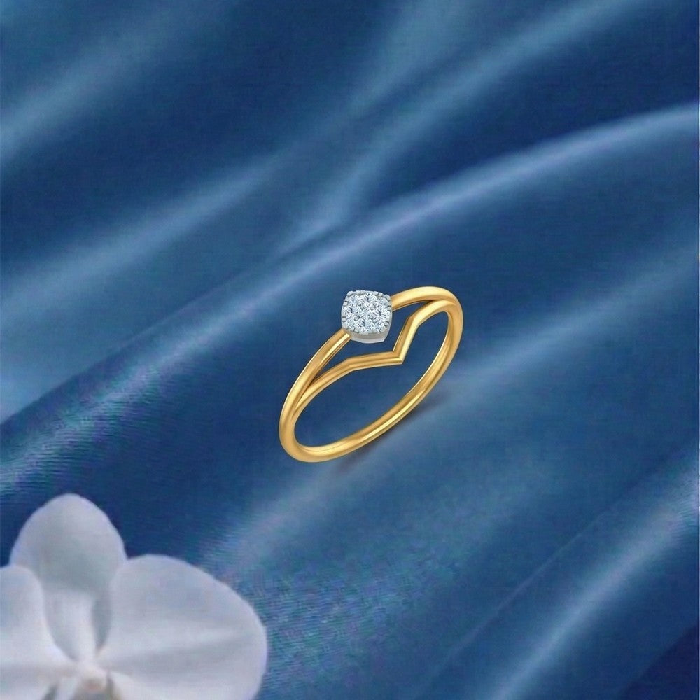 Gold and diamond with cluster setting on a blue fabric surface.