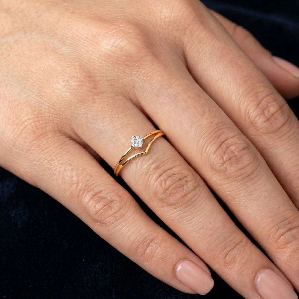 Close-up shot of a gold and diamond with cluster setting ring.