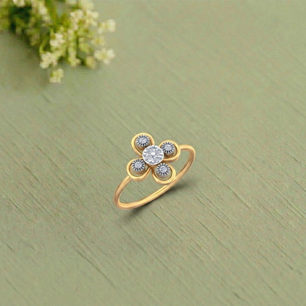 Gold and diamond with floral-design setting on a green texture surface.