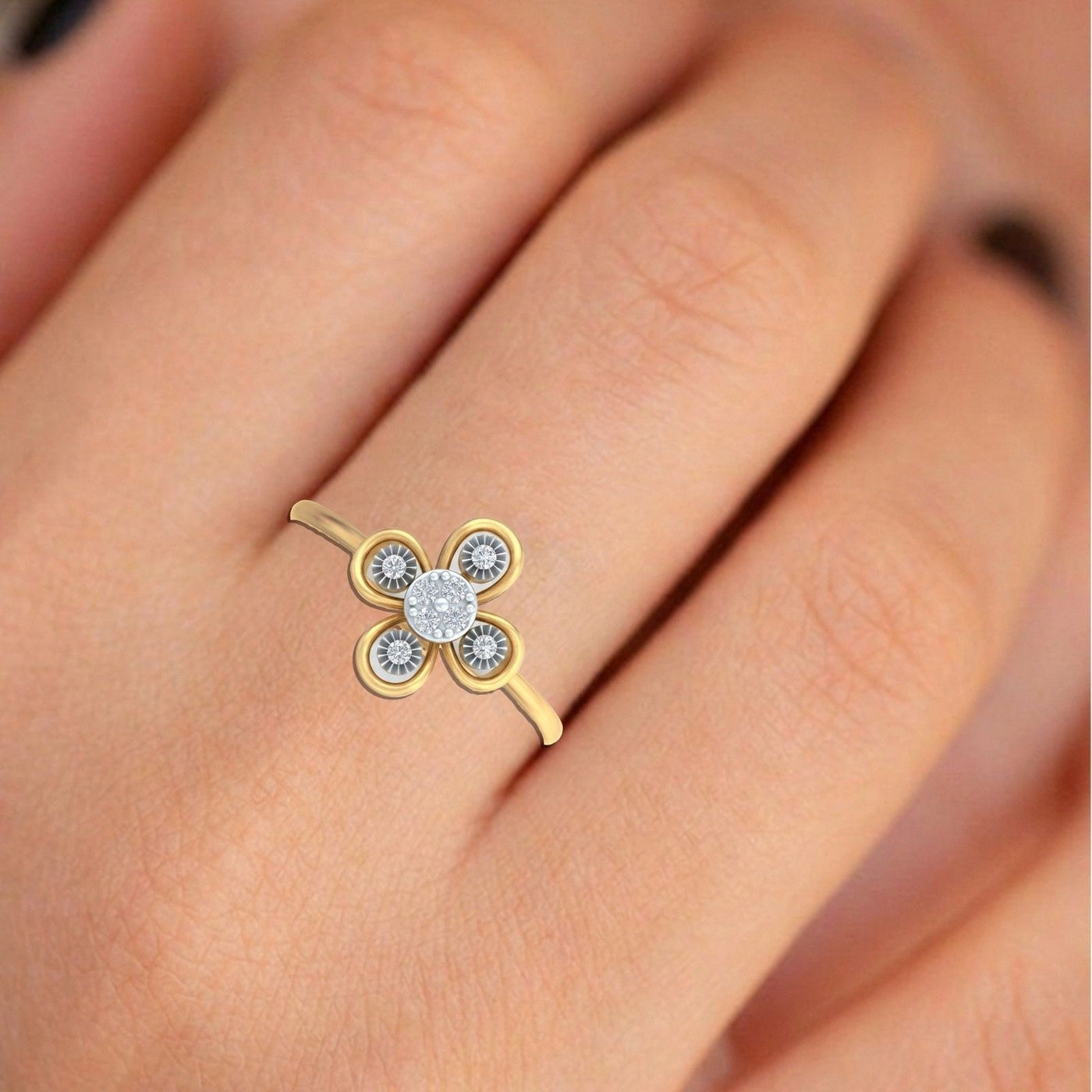 Close-up shot of a gold and diamond with floral-design setting ring.