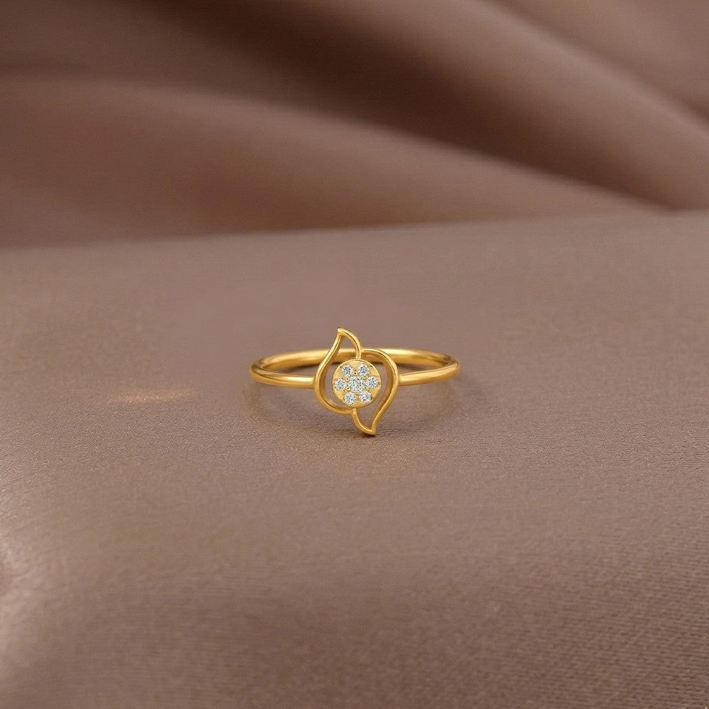 Gold and diamond with round-shaped cluster setting on a brown surface.