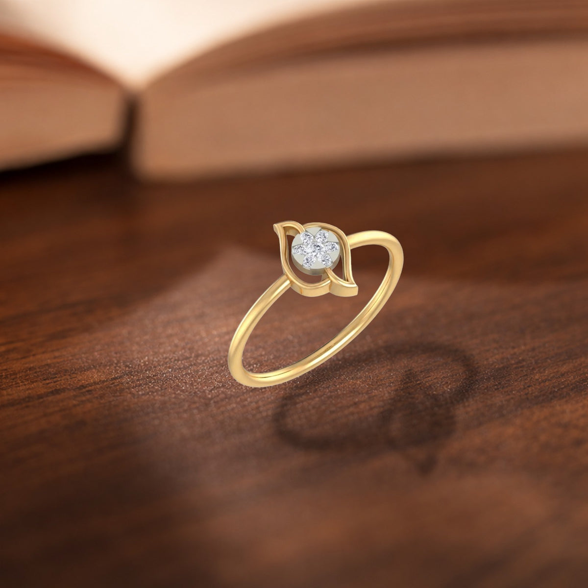 Gold and diamond with round-shaped cluster setting on a wooden surface.