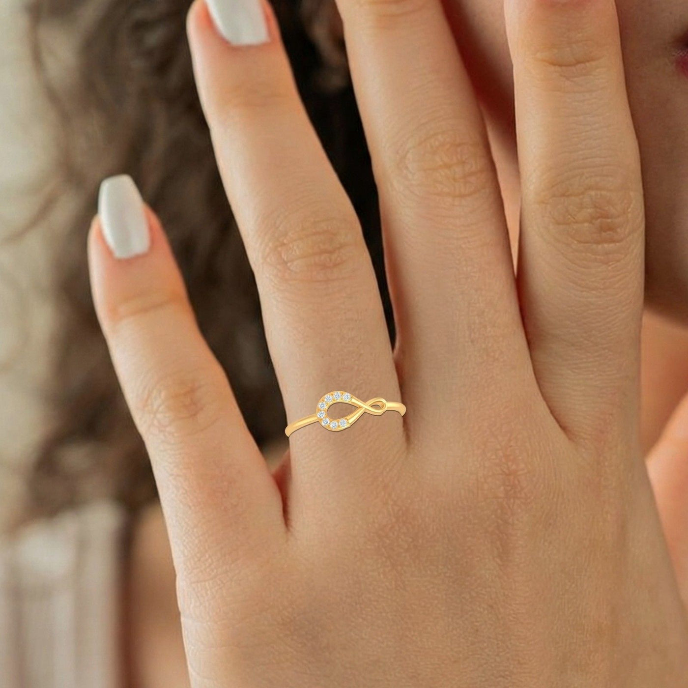 Close-up shot of a gold and diamond women's ring.
