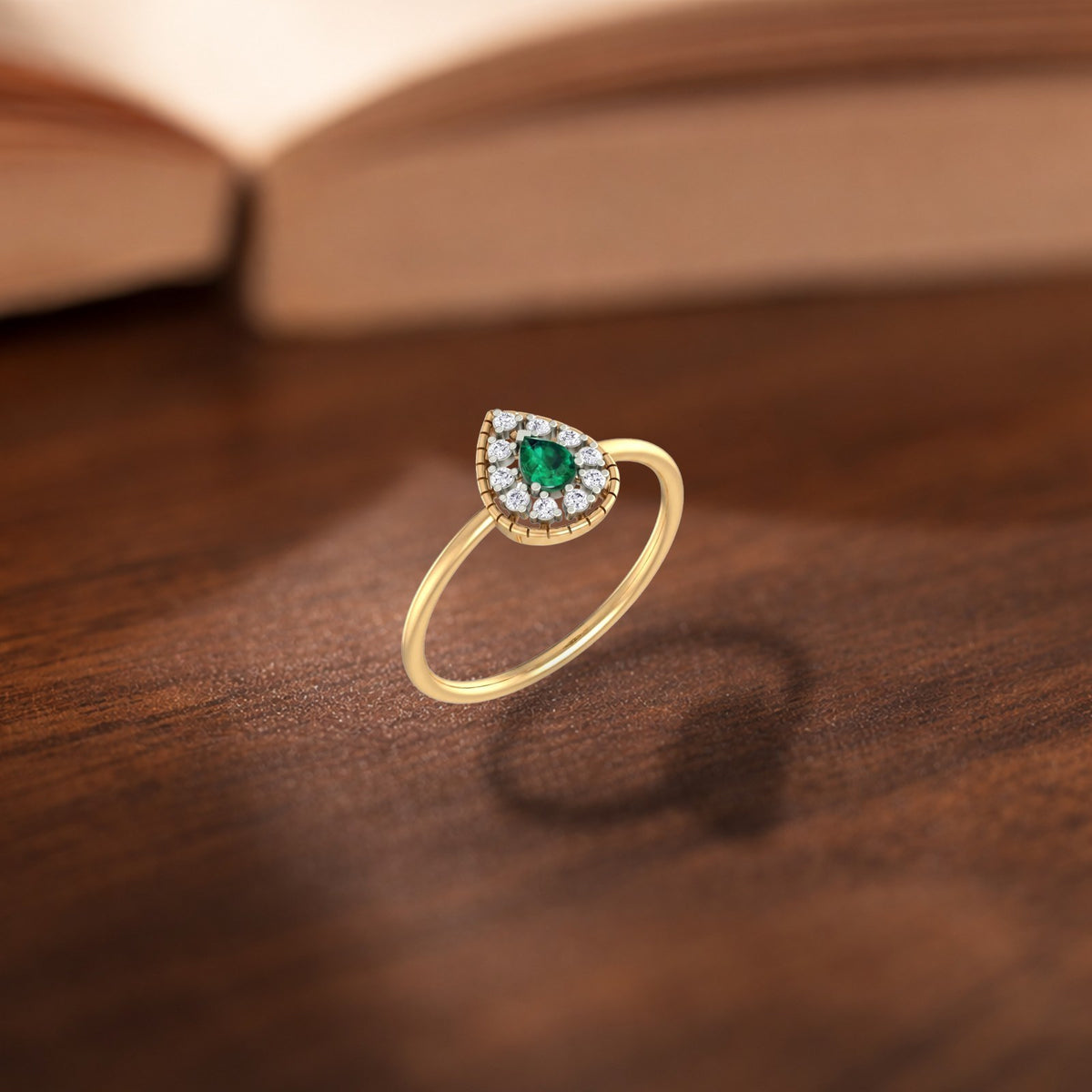 Gold and diamond with teardrop emerald gemstone setting ring.